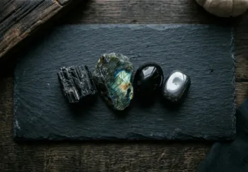 Flat lay of protection stones on dark slate surface